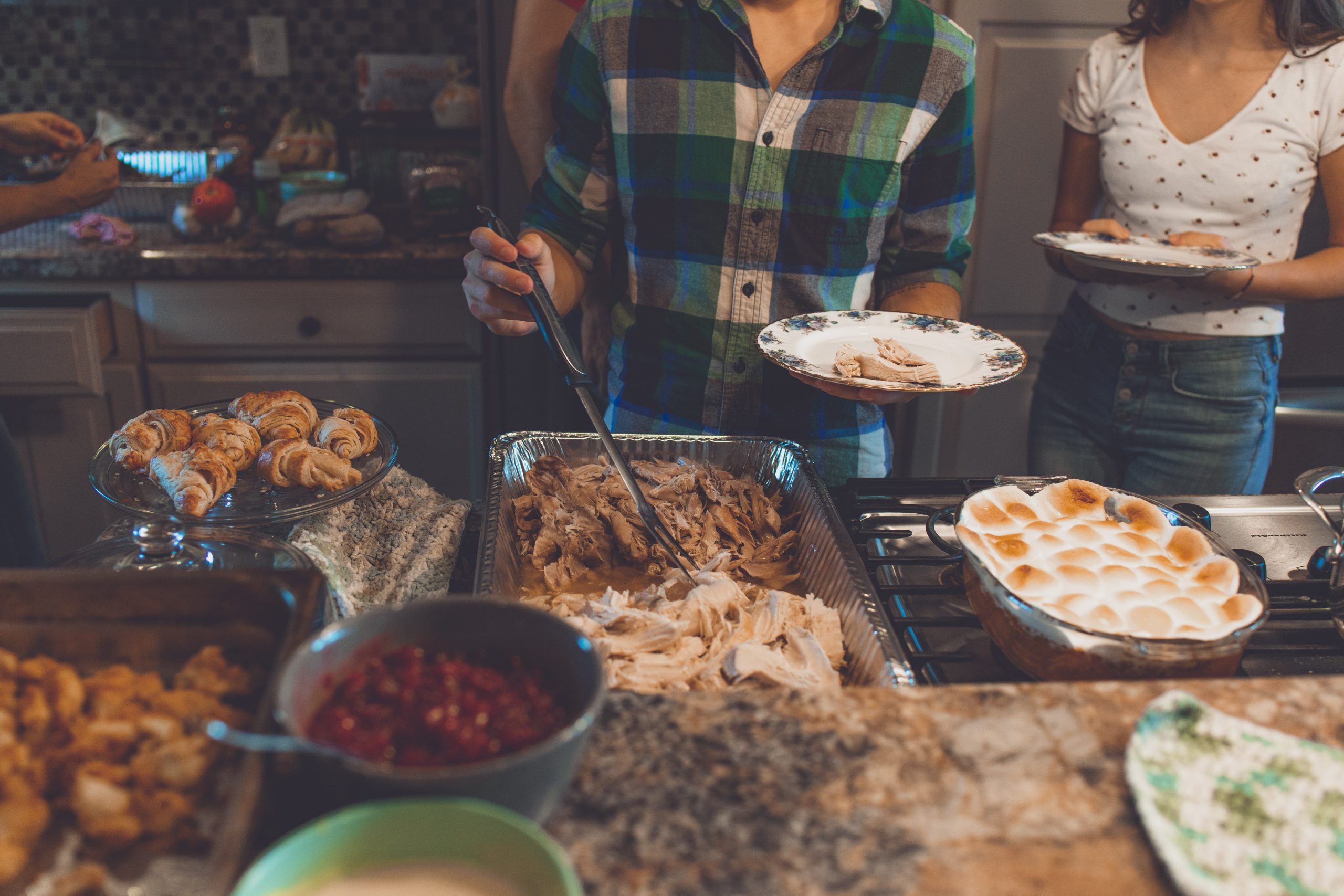 People Getting Food at Friendsgiving Celebration